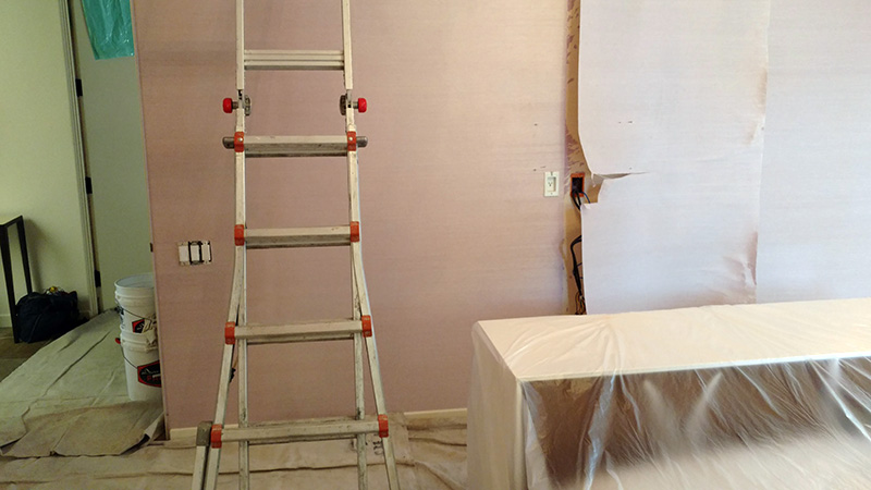 Professional wallpaper removal in progress in Huntington Beach, CA